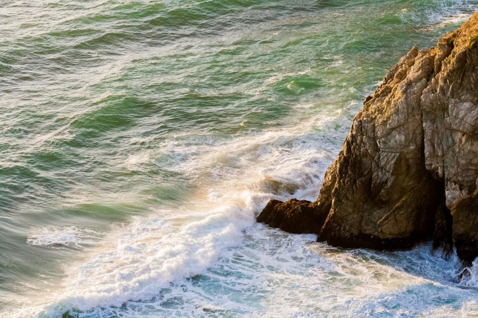 Free Image of Man Riding Surfboard on Wave-Covered Ocean 