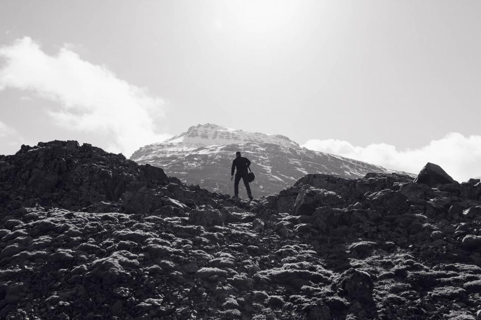 Free Image of Man Standing on Top of Rocky Mountain 
