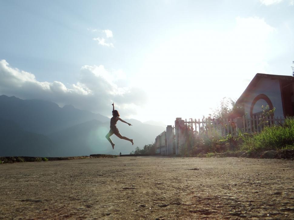 Free Image of Person Jumping in the Air With a Frisbee 