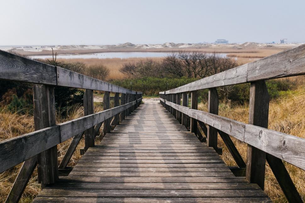 Free Image of Wooden Bridge Crossing Dry Grass Field 