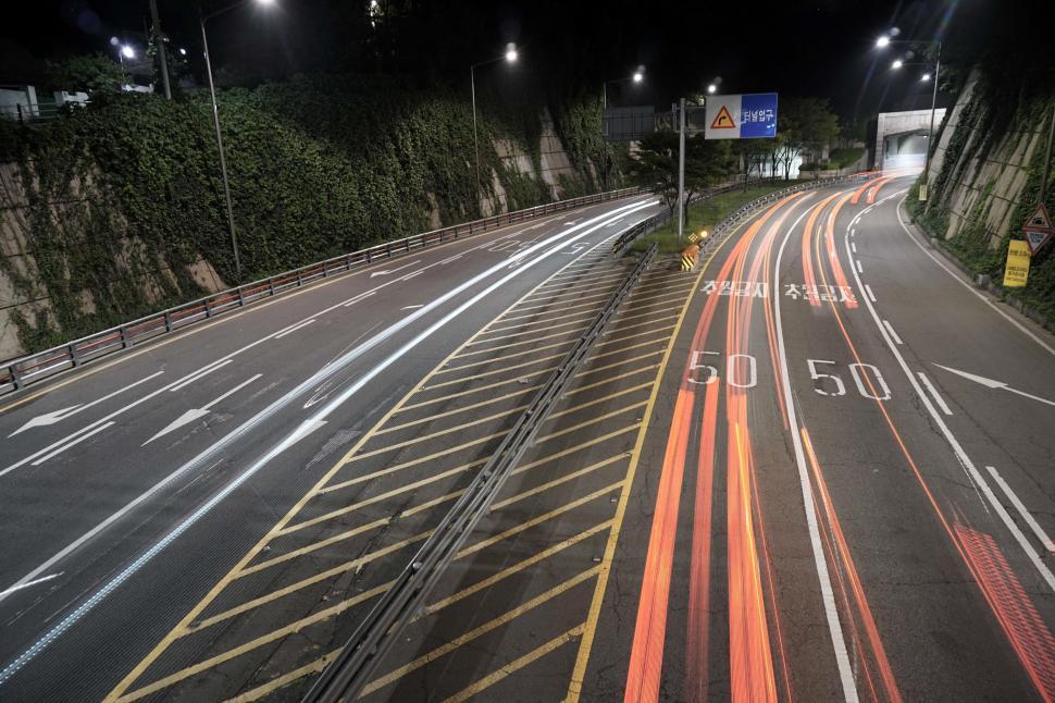 Free Image of Empty Highway at Night With Lights On 