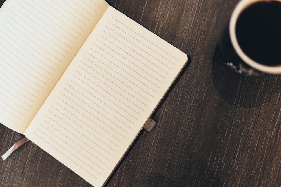 Free Image of A Cup of Coffee and a Notebook on a Table 