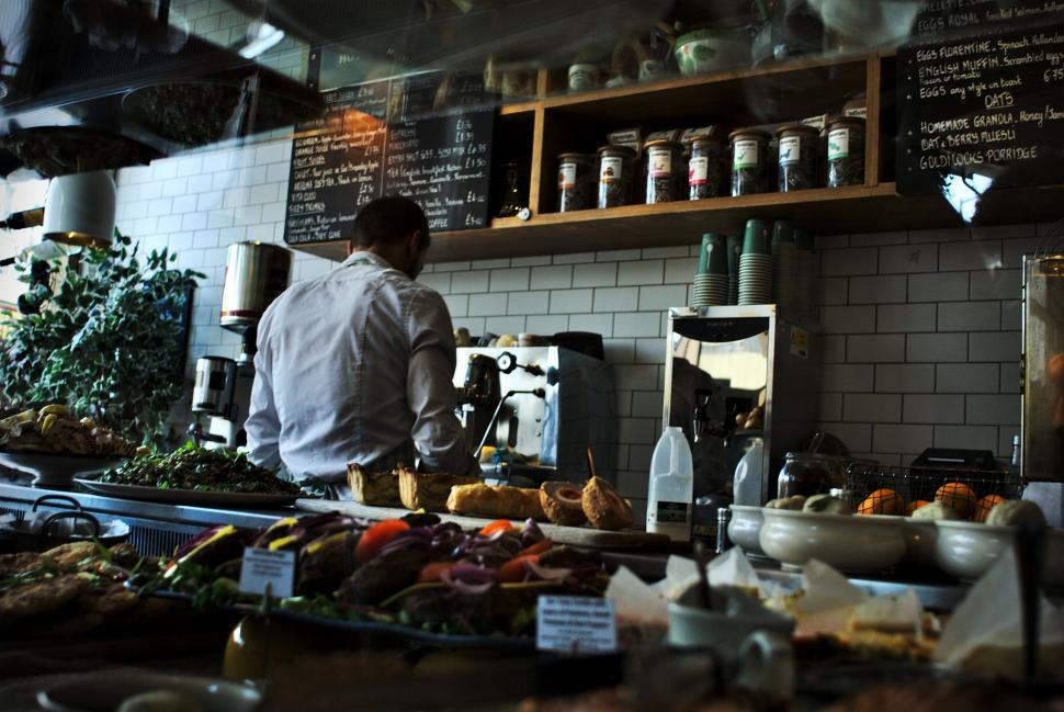 Free Image of Man Standing in a Kitchen Preparing Food 