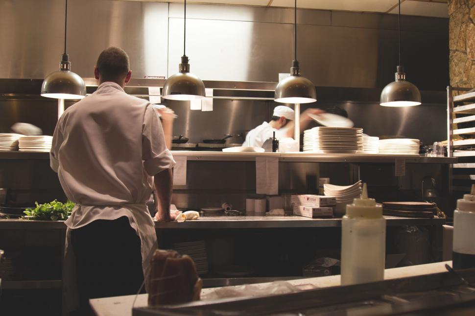 Free Image of Man Standing in Kitchen Preparing Food 