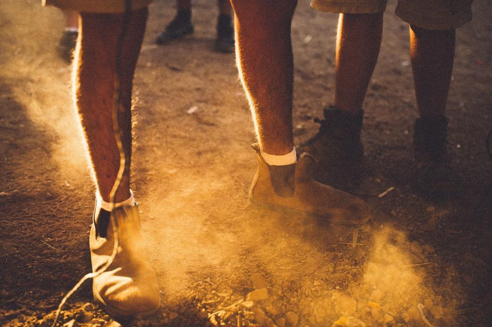 Free Image of Group of People Walking Down a Dirt Road 