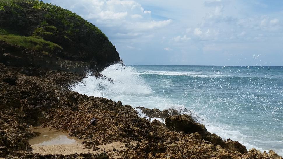 Free Image of Person Riding Surfboard on Rocky Beach 