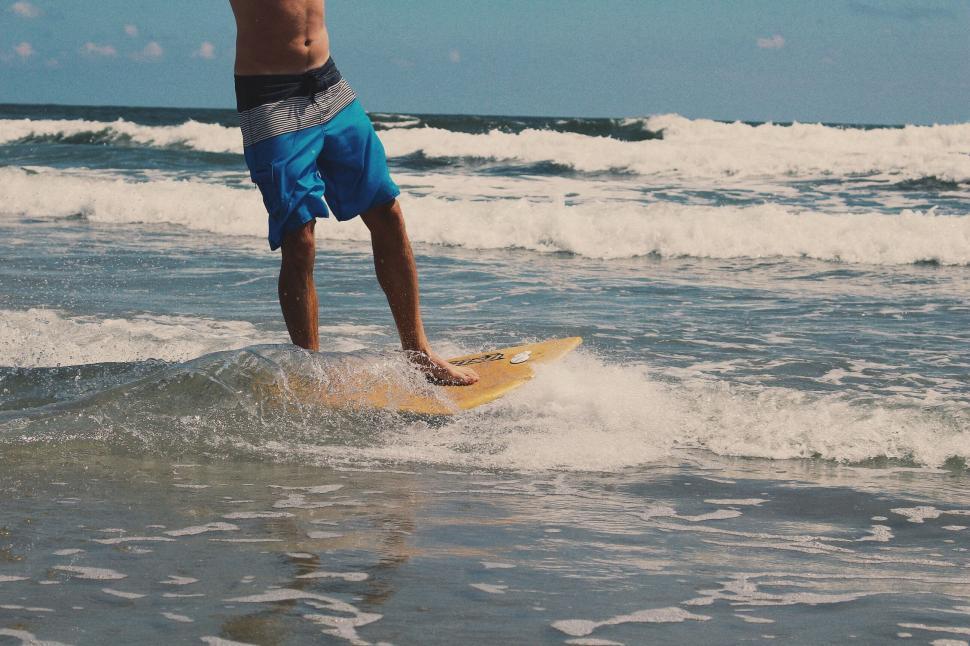 Free Image of Man Riding Wave on Surfboard 