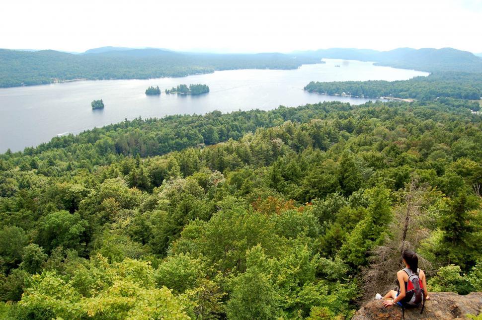 Free Image of Person Sitting on Rock Overlooking Lake 