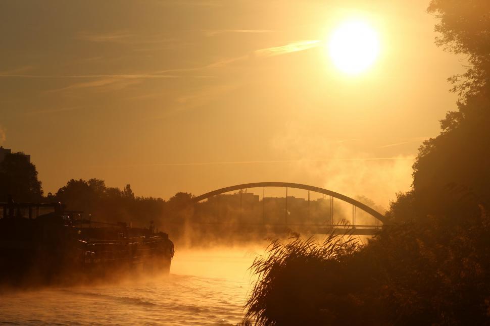 Free Image of Boat Traveling Under Bridge on River 