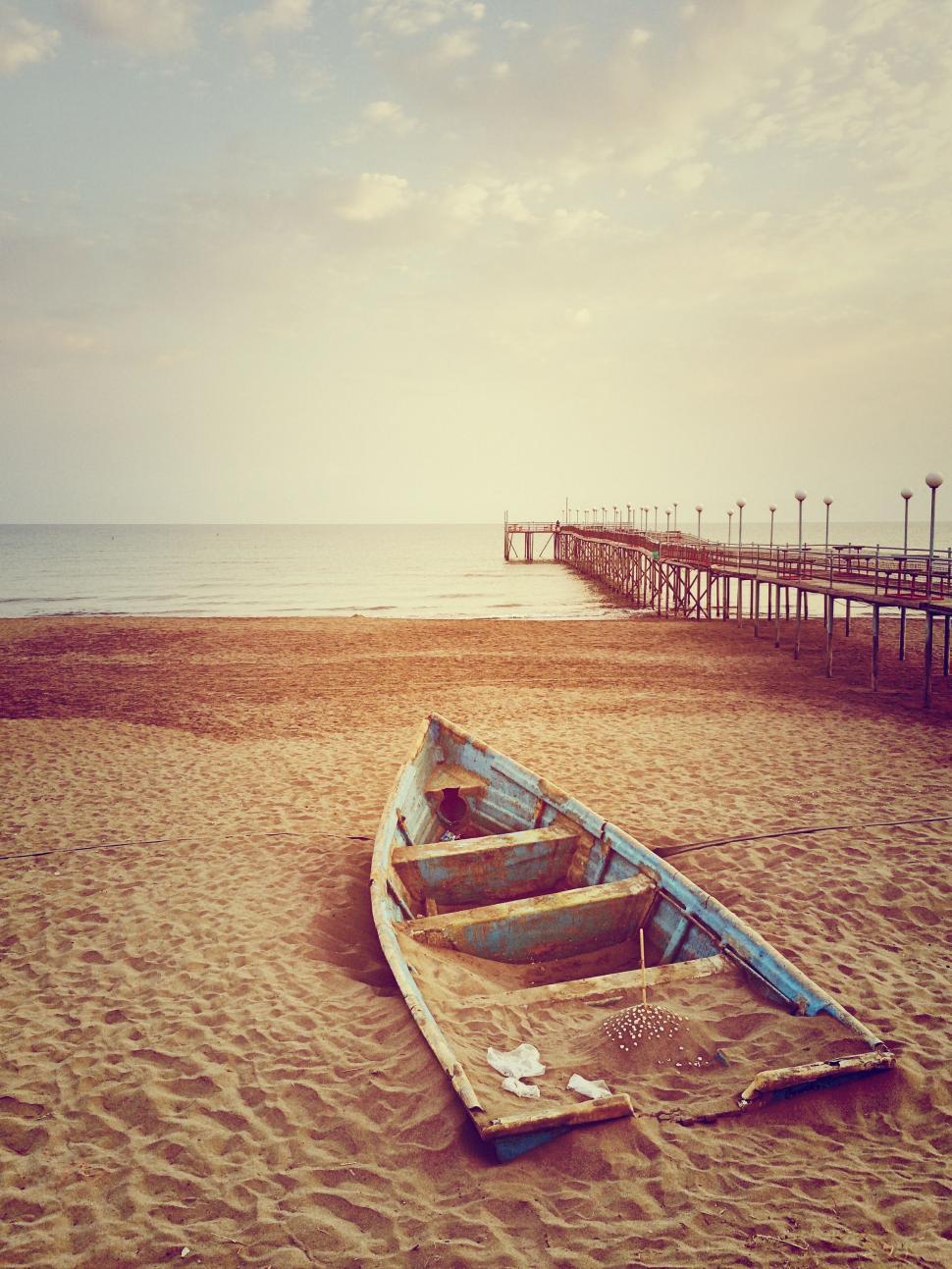 Free Image of Boat Resting on Sandy Beach 