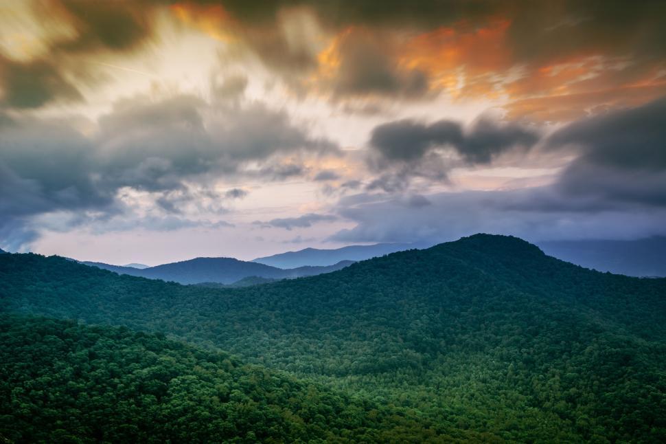 Free Image of Clouds Hovering Over Majestic Mountain Range 