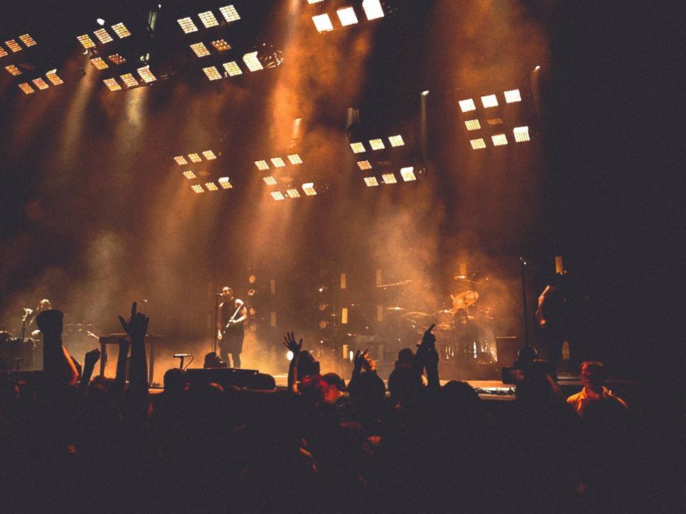 Free Image of Group of People Standing on Top of a Stage 