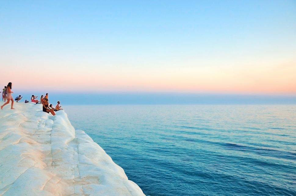 Free Image of Group of People Standing on Top of Snow Covered Cliff 