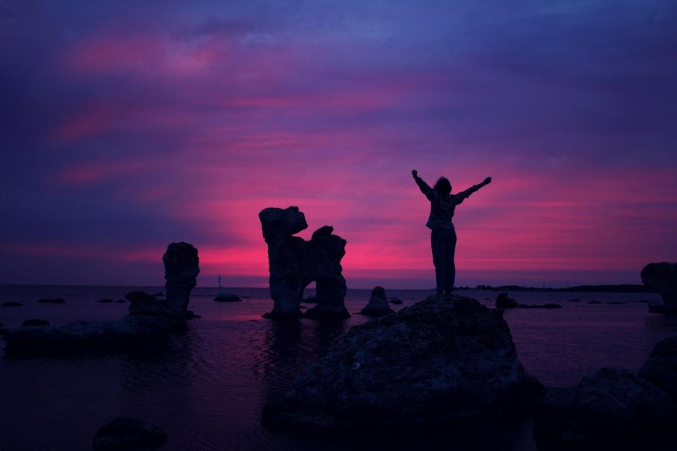 Free Image of Group of People Standing on Top of a Beach 