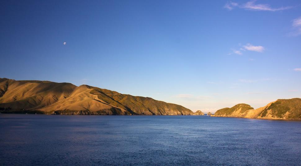 Free Image of Mountain-Encircled Lake Under Clear Blue Sky 