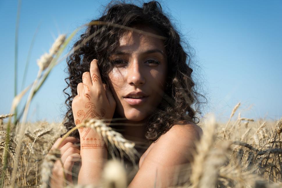 Free Image of Woman Standing in a Field of Wheat 