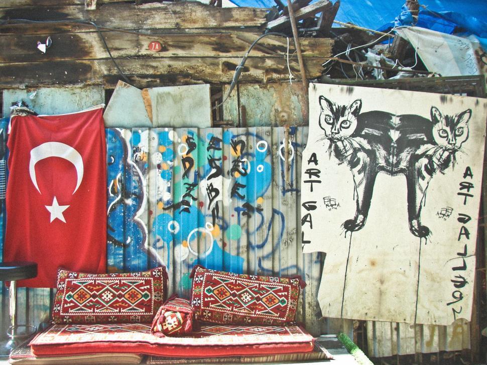 Free Image of Bed Against Graffiti Wall 