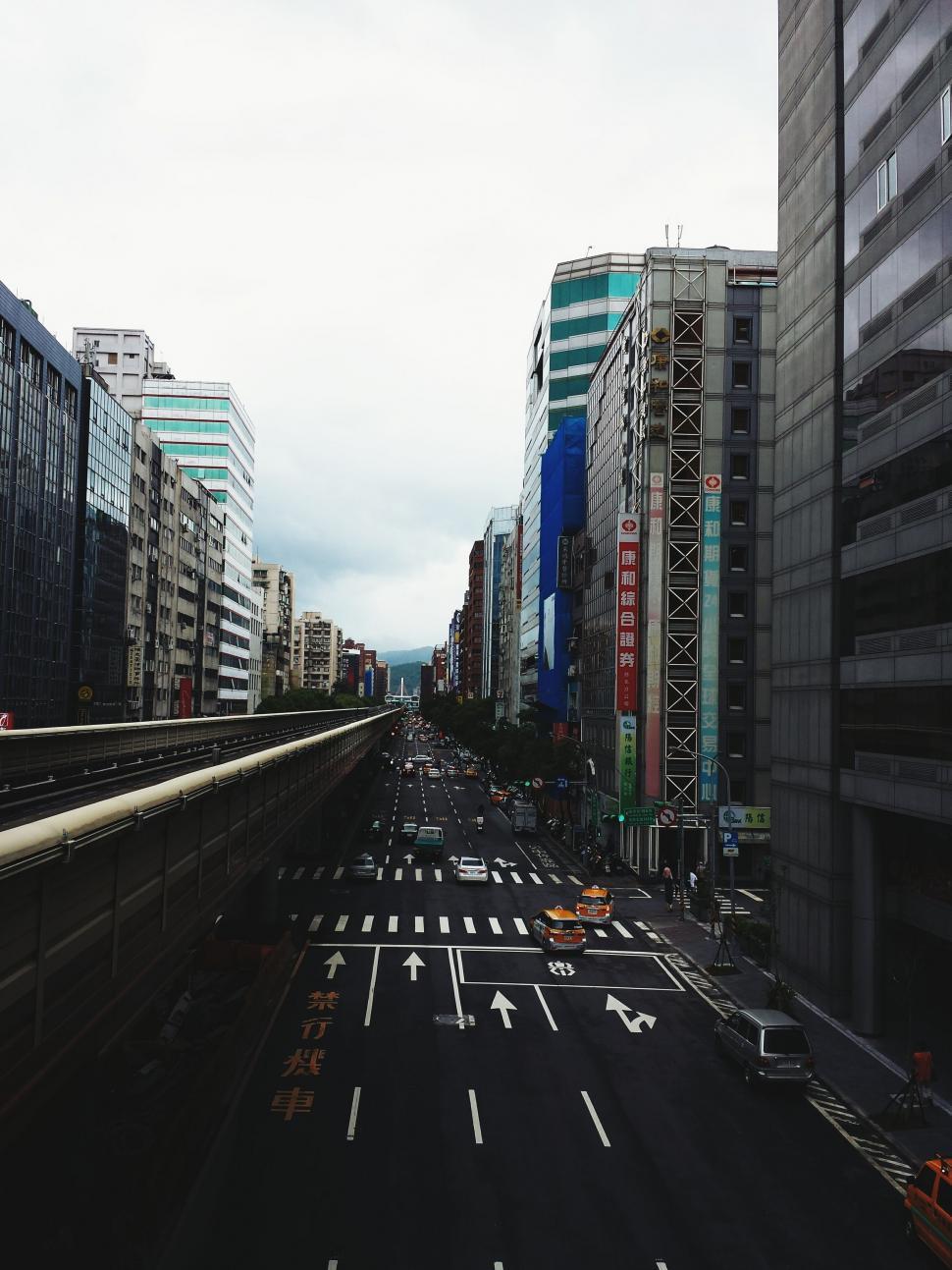 Free Image of City Street With Buildings and Train 