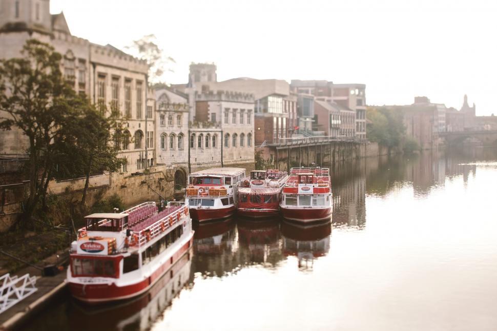 Free Image of Group of Boats Floating on Top of River 