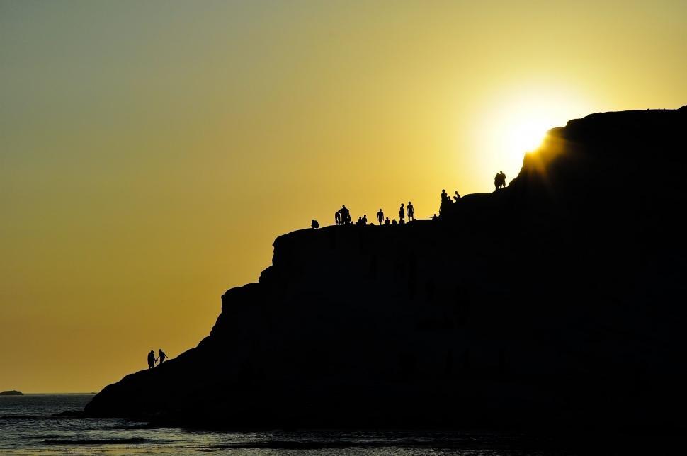 Free Image of Group of People Standing on Top of a Cliff 