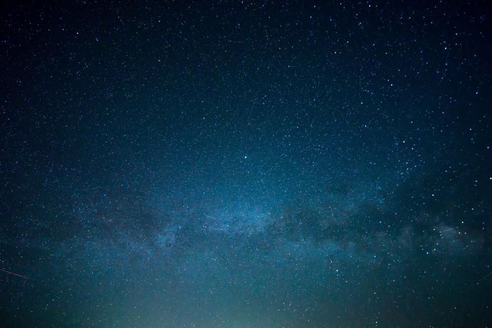 Free Image of Person Standing on Beach Under Night Sky 