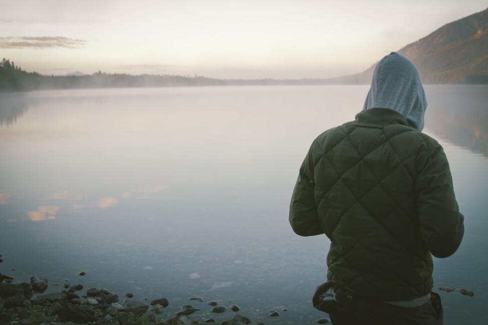 Free Image of Person Standing on Shore of Lake 