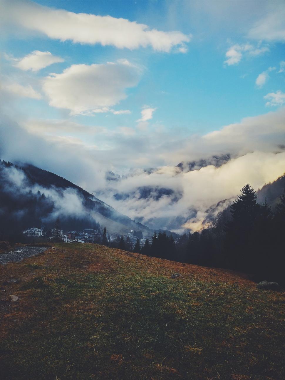 Free Image of Person Standing on Top of Grass Covered Hill 