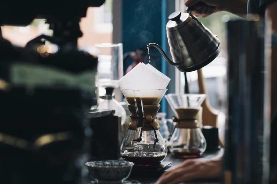 Free Image of Person Pours Coffee From Coffee Maker 