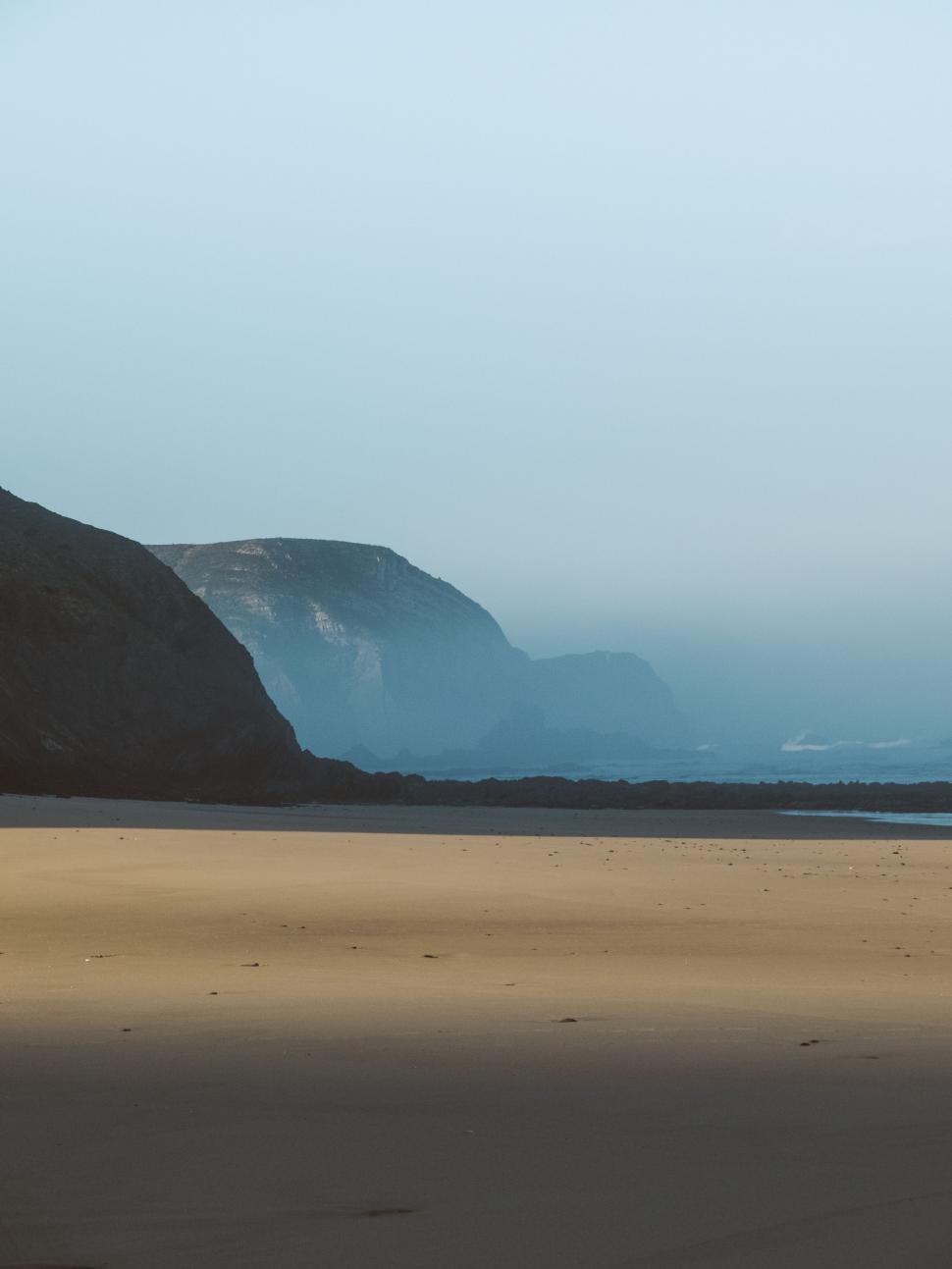 Free Image of Beach With Mountain in Background 