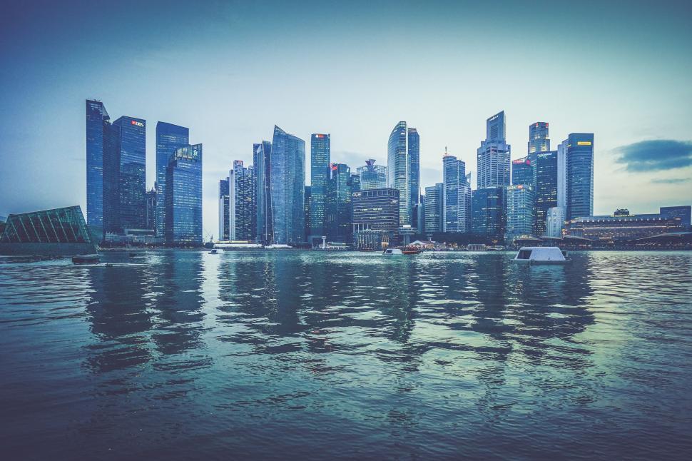 Free Image of City Skyline Overlooking Vast Body of Water 