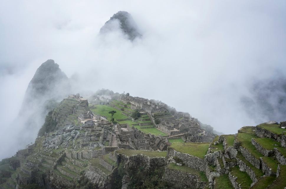 Free Image of Tiny Structure Atop Towering Mountain 