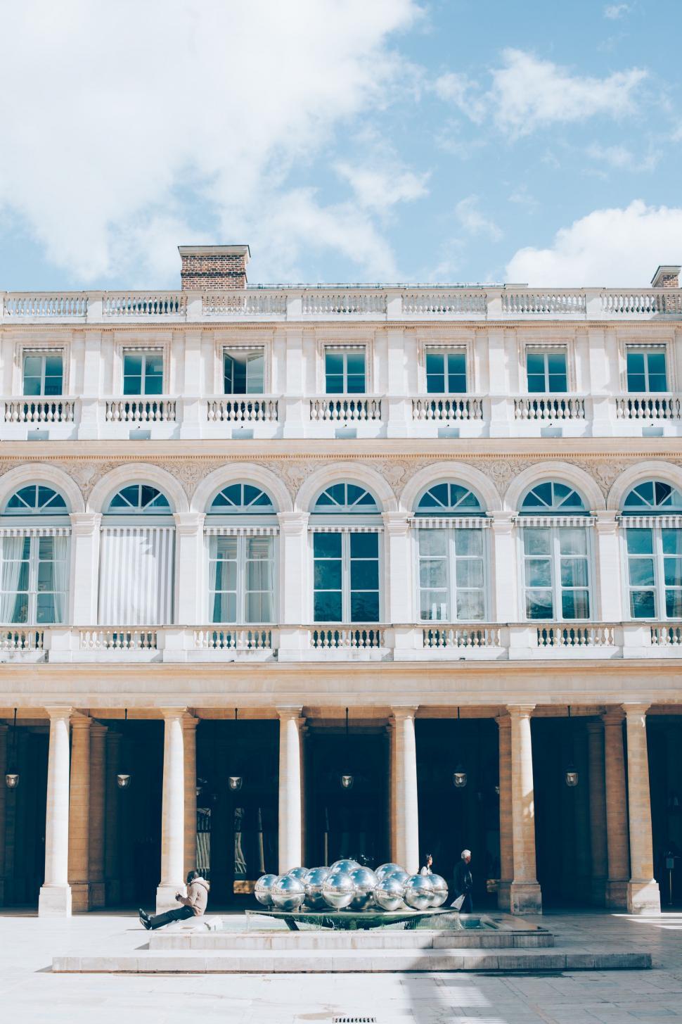Free Image of Large White Building With Fountain in Front 