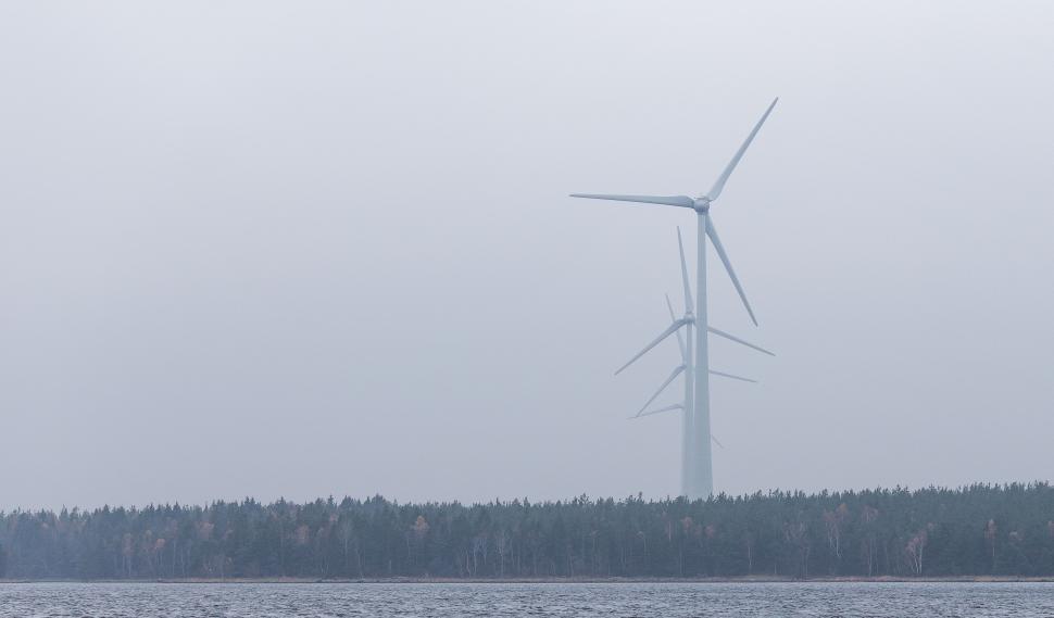 Free Image of Wind Turbine on a Foggy Day Over Body of Water 