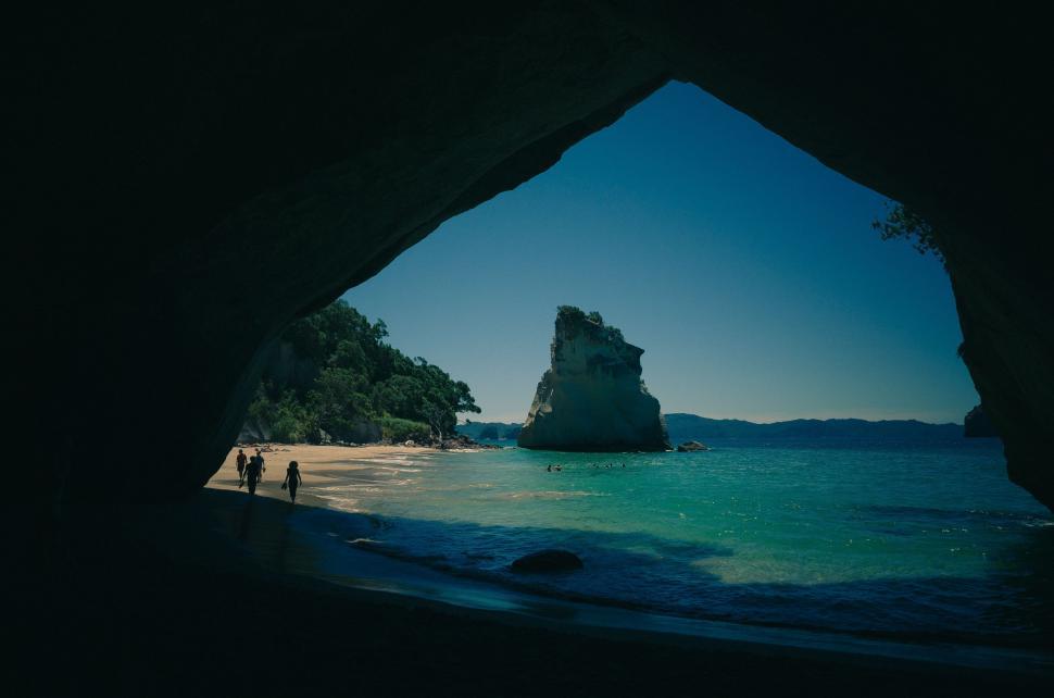 Free Image of Group of People Standing on Top of Sandy Beach 