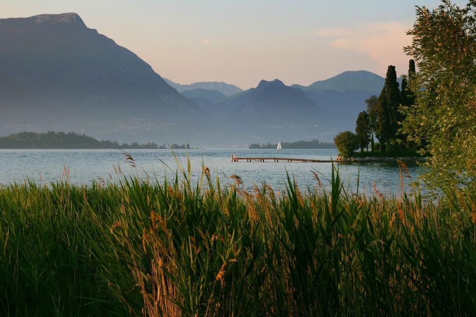 Free Image of Majestic Mountains Towering Over Serene Lake 