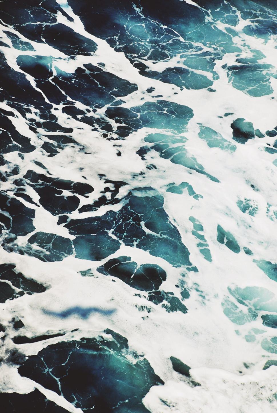 Free Image of Large Body of Water Covered in White Foam 