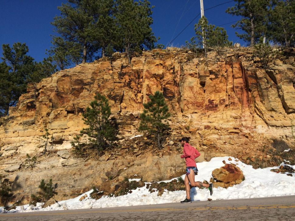 Free Image of Person Running in Snow Near Mountain 
