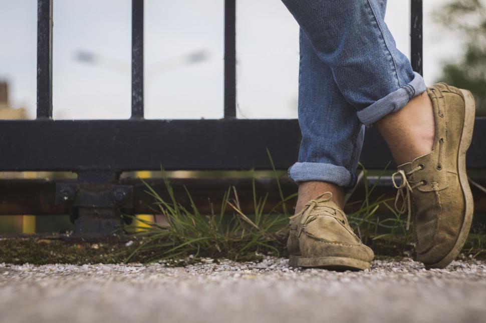 Free Image of Person Standing in Front of Metal Fence 