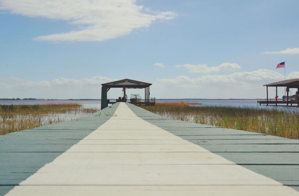 Free Image of Flag-topped Pier by Water 
