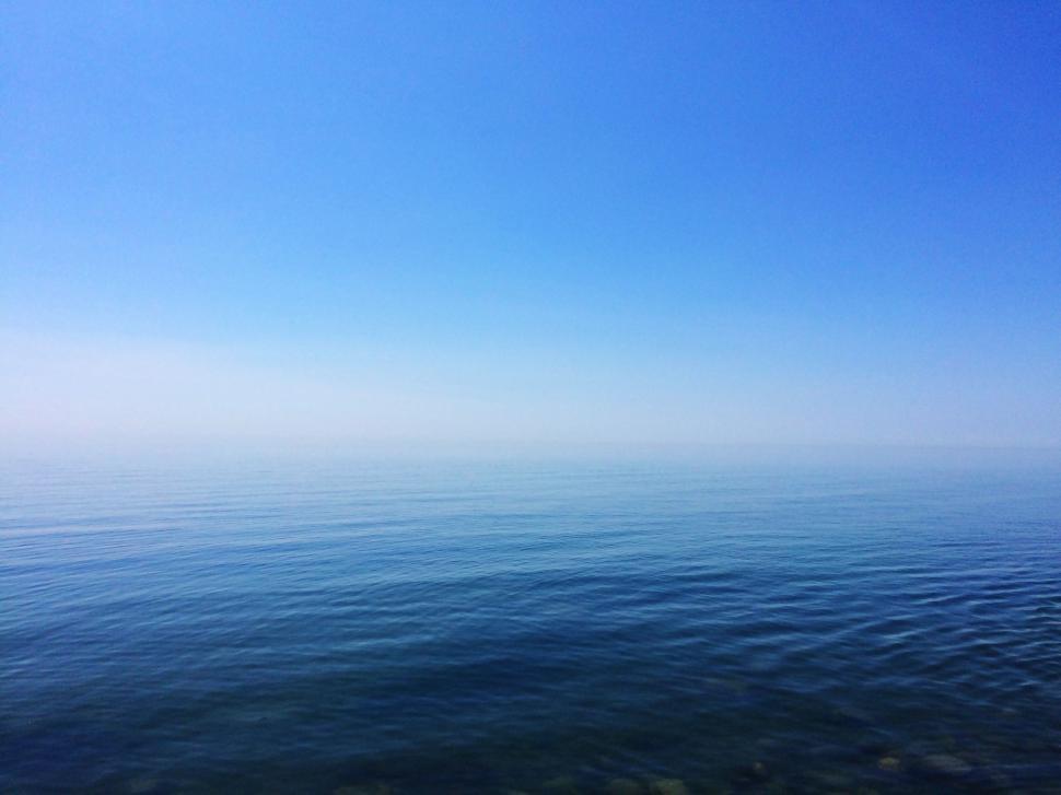 Free Image of Large Body of Water Under Blue Sky 