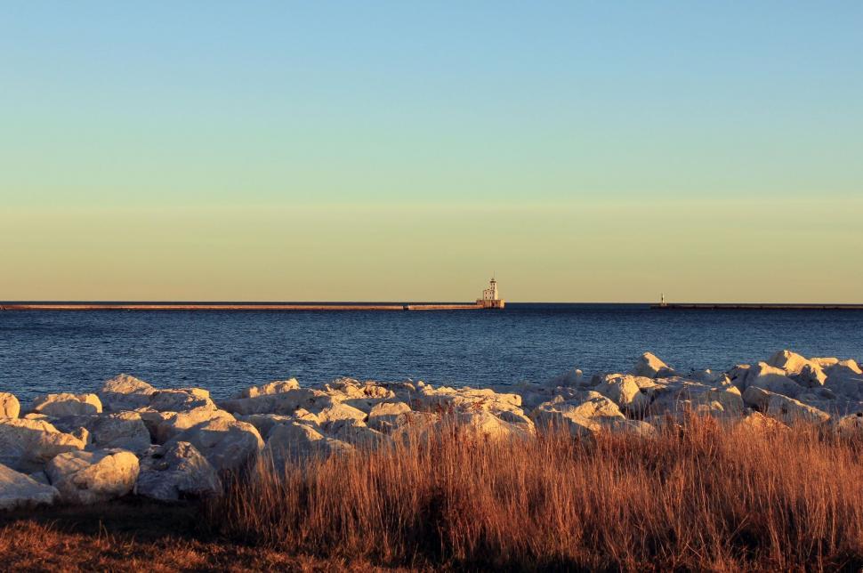Free Image of Large Body of Water Surrounded by Rocks 