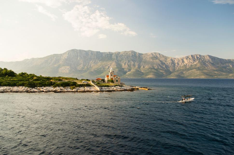 Free Image of Small Boat Sailing on Vast Open Water 