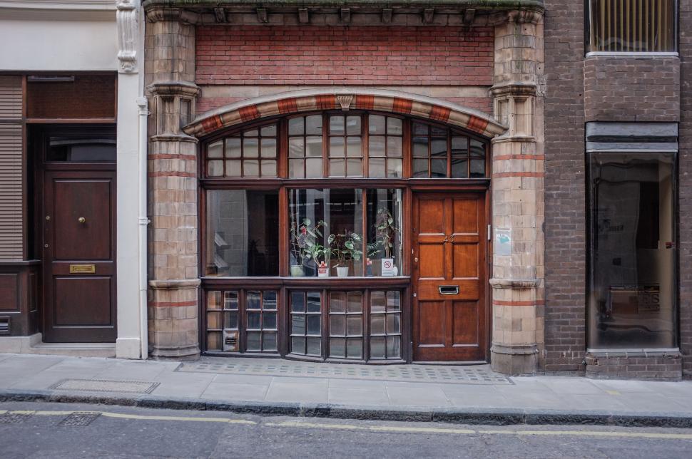 Free Image of Brick Building With Wooden Door and Windows 