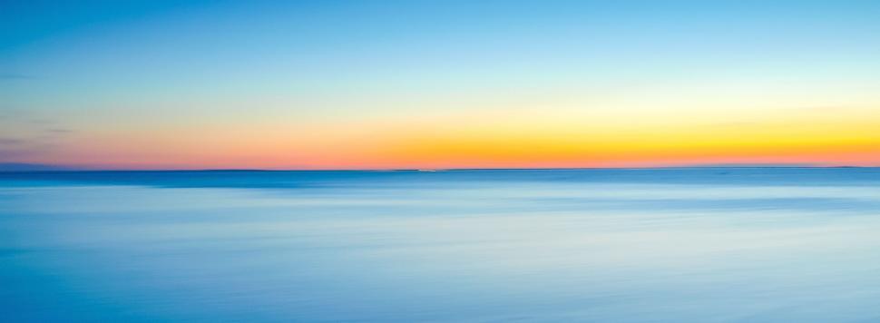 Free Image of Sunset Over a Body of Water 