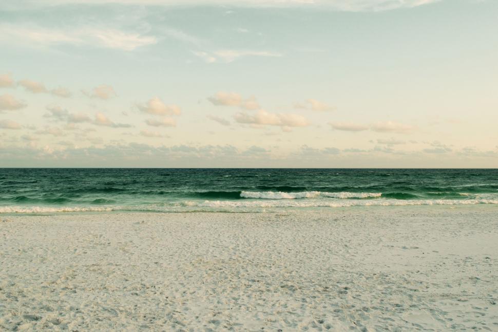Free Image of Person Walking on Beach With Surfboard 