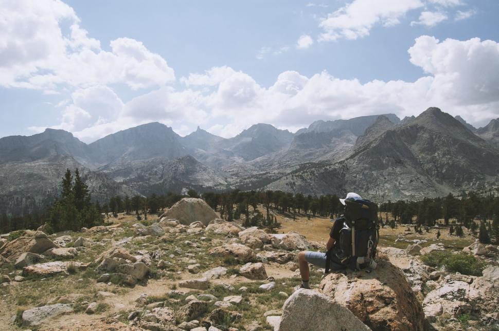 Free Image of Person Sitting on Rock in Mountains 