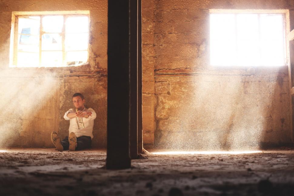 Free Image of Young Boy Sitting on Floor in Room 
