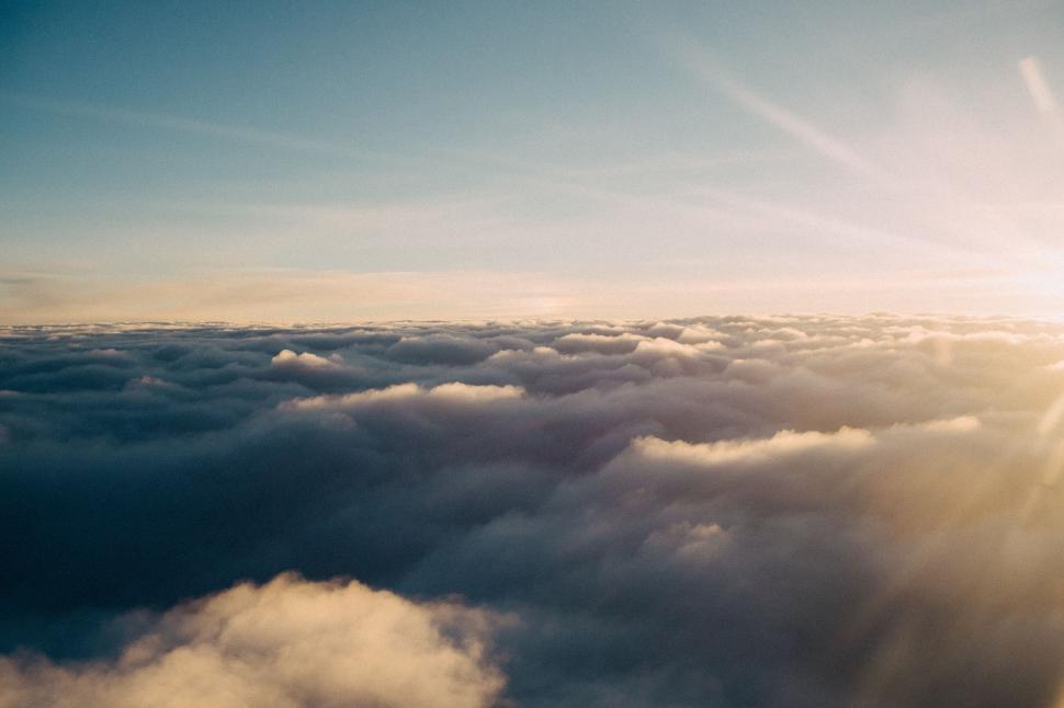Free Image of Sun Shining Above Clouds in Sky 