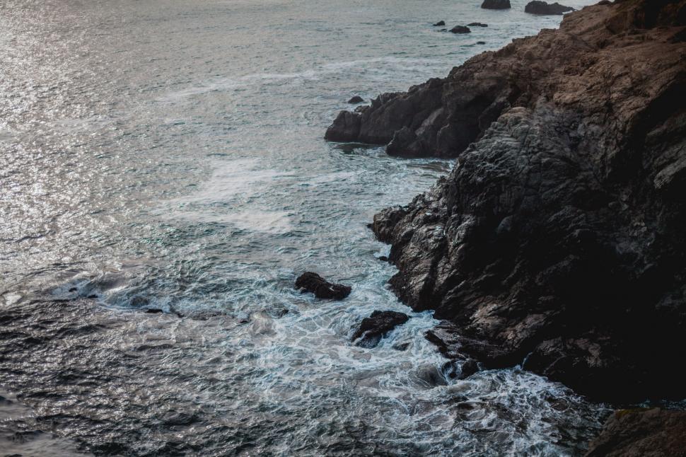 Free Image of Ocean Waves Crashing Against Rock Formation 