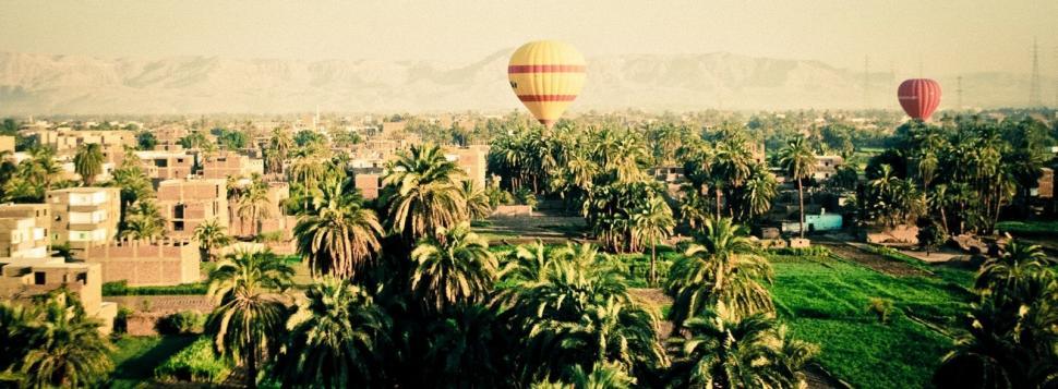 Free Image of Two Hot Air Balloons Flying Over City 